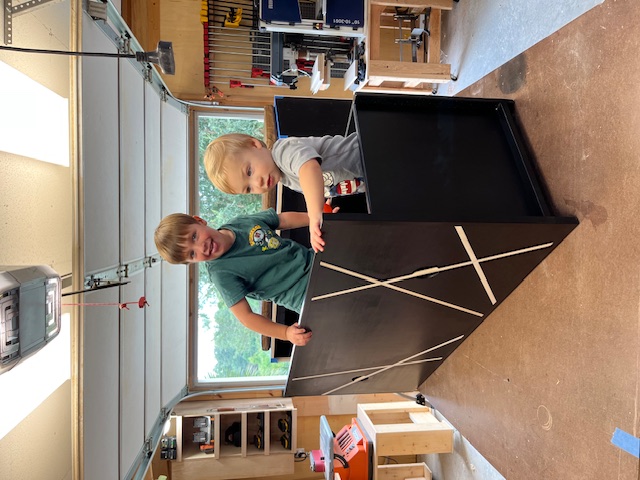 Two children turning the Window Bench drawer into a place to play